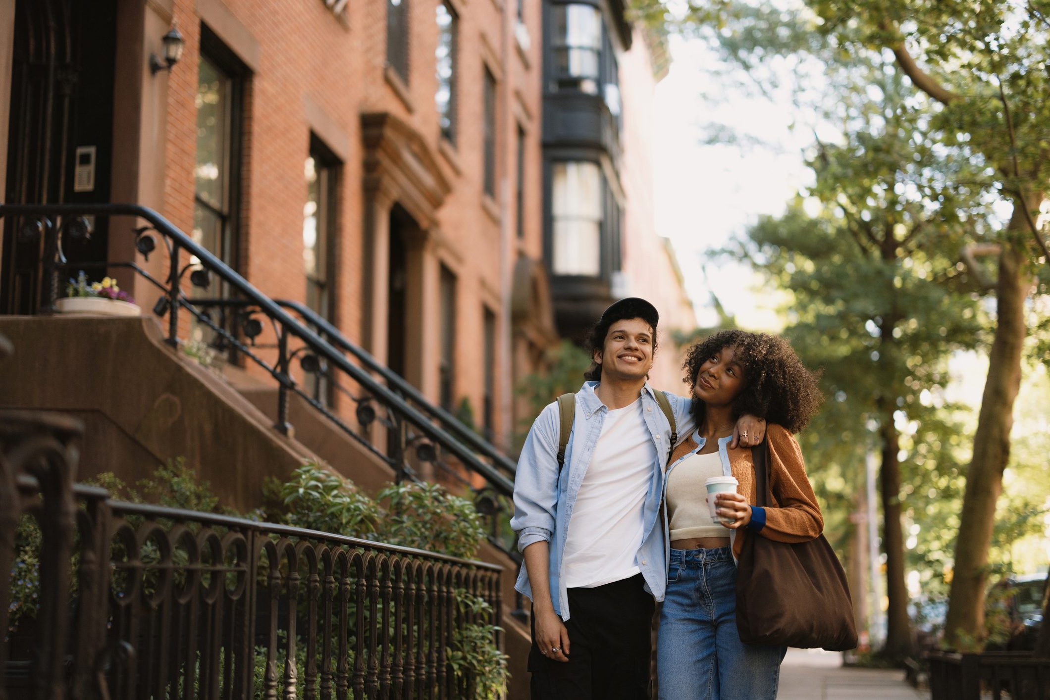 Young couple walking in New York City and looking up